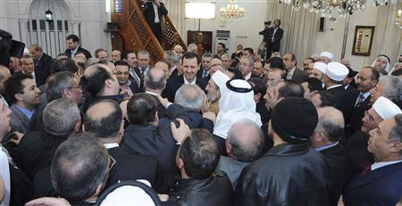 Syria's President Bashar al-Assad greets people after attending prayers during celebrations of Prophet Mohammed's birthday at the al-Afram mosque in Damascus