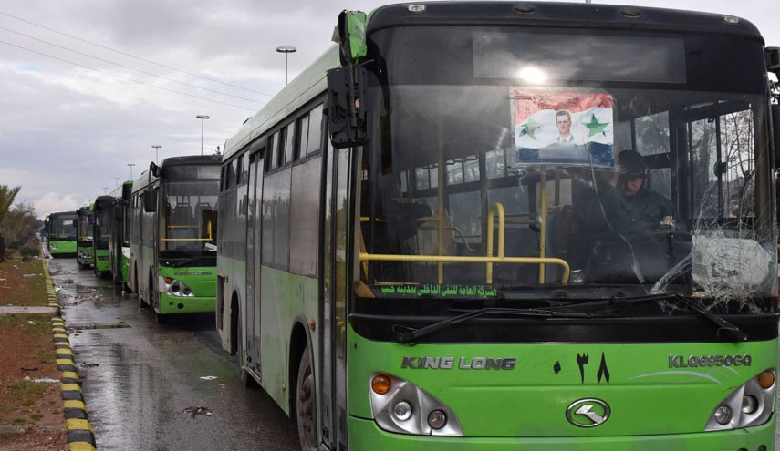 Buses which will be used to evacuate civilians leaving from rebel-held areas of Aleppo are seen waiting on December 14, 2016. Thousands of cold and hungry civilians crowded the streets of Aleppo uncertain of their future after their planned evacuation from the last rebel pocket of the city was delayed, according to AFP.